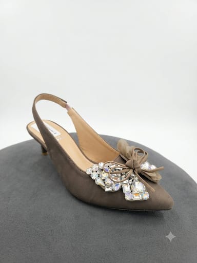 "Sparkle-ready white slingback heels with a crystal bow detail. Comfy kitten heel, timeless pointed toe. Shop bridal & nikah night must-haves now.