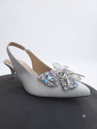 "Sparkle-ready white slingback heels with a crystal bow detail. Comfy kitten heel, timeless pointed toe. Shop bridal & nikah night must-haves now.